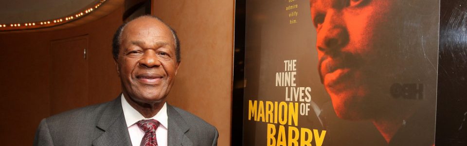 Marion Barry, former mayor of DC, posing next to a poster for the documentary on his life: The Nice Lives of Marion Barry. Flavorlab provided original score and mix for the film.