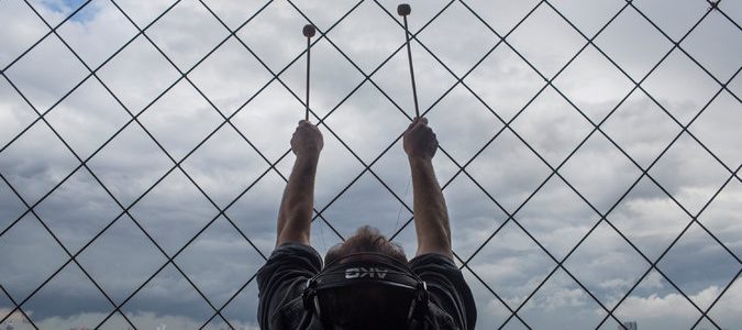 Still of a man hitting mallets against the Eiffel Tower in "Turning The Eiffel Tower Into A Musical Instrument"