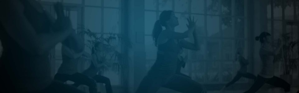 Still of a woman in a ponytail doing tai chi in front of a large window in a Florastor ad. Flavorlab Score provided original music for the spot.